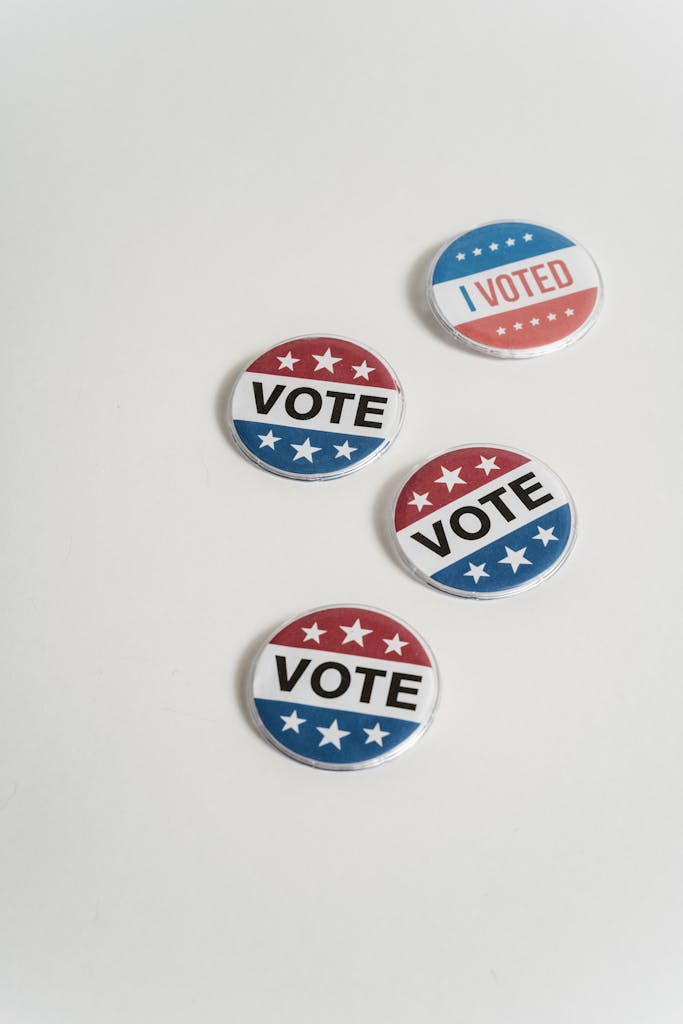 Vote and I Voted Pin-Back Buttons on a White Surface